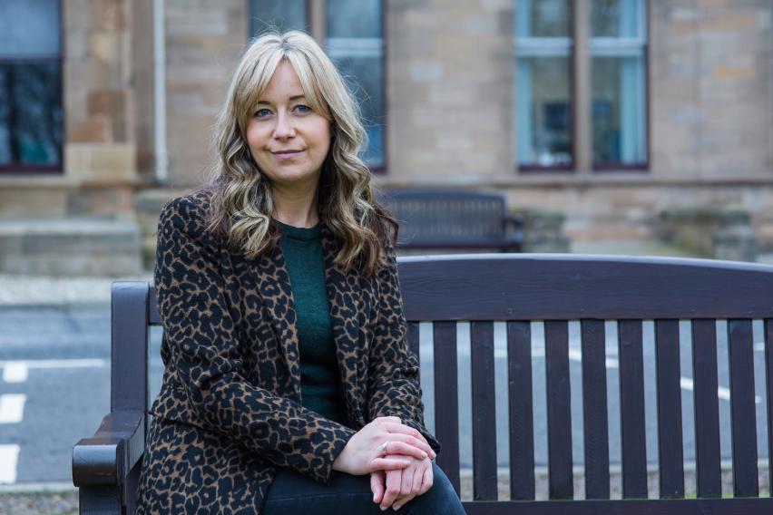 portrait picture of UNESCO resident Sarah Stewart. A woman is sitting on a bench.